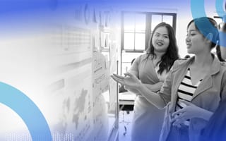 Three product managers look at a whiteboard