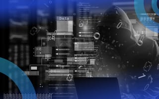 A cybercriminal in a hoodie works on a laptop with an overlay of icons