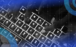 Hands typing on a glowing keyboard