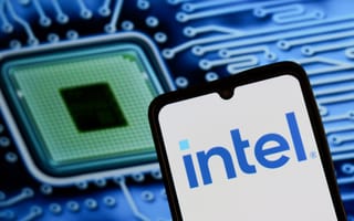 A smartphone displays the Intel logo in front of a blurred background image of a computer chip and circuit board.