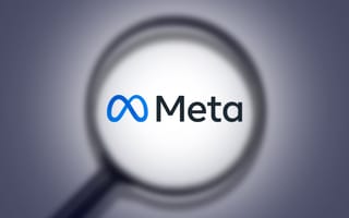 A magnifying glass over the Meta logo.