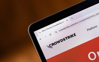 Close-up of a computer screen displaying the CrowdStrike webpage with logo and text "Why Choose CrowdStrike."