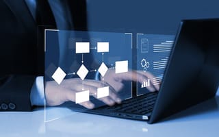 A person typing on a laptop is pictured with an illustration of a flow chart hovering over the keyboard.