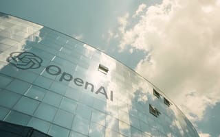 Image looking up at front facade of OpenAI office, with clouds hovering above.