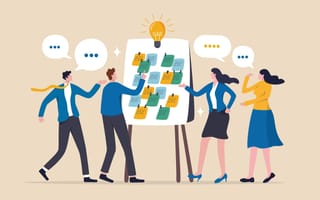 An illustration of four professionals, with thought bubbles hovering above them, pointing toward sticky notes on a whiteboard, symbolizing the idea of sharing knowledge