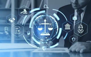 A man in a business suit sits behind a desk signing a document with a pen. Above his desk is a glowing, blue digital overlay of icons, including a central scale of justice surrounded by symbols for a gavel, a courthouse, and other legal concepts.