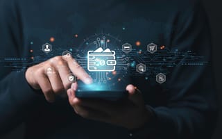A finger points to the screen of a mobile device with a wallet hovering over it to represent mobile wallet and crypto technology.