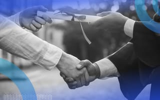 A graduate shakes hands and receives a diploma