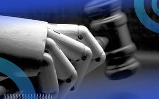 A robot hand holding a gavel