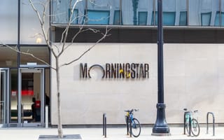 Morningstar to Acquire CRSP from University of Chicago for $375M Street view of a modern building entrance featuring "Morningstar" sign on beige wall. Three bicycles are parked nearby, and a barren tree stands close by.