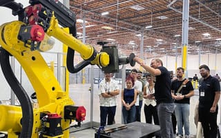 GrayMatter Opens Advanced Robotics Headquarters Facility A GrayMatter team member demonstrates a robot to a crowd of onlookers.