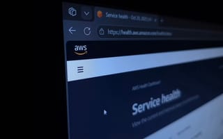 close-up photo of a computer screen displaying the AWS Service Health Dashboard webpage, showing the AWS logo and a browser tab labeled “Service health – Oct 20, 2025.”