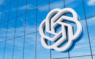 OpenAI's logo on the side of a building is shown.