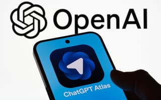 Silhouette of a hand holding a smartphone with OpenAI’s Atlas on its screen, agains the background of the OpenAI logo