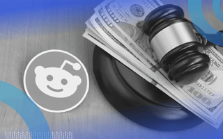 A Reddit logo next to a gavel atop a stack of $100 bills