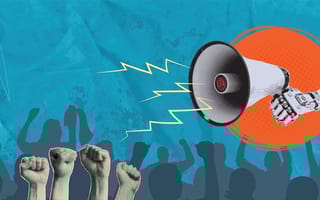 Is Your Chatbot Really ‘Woke’? The Truth Behind the AI Culture War A robot arm holding a megaphone over a crowd of protesters with their fists in the air.