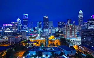 A view of the Charlotte, North Carolina skyline at night featuring several skyscrapers.