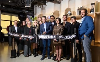The SharkNinja executive team is pictured cutting a ribbon.