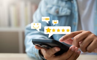 A person in a denim jacket taps a smartphone screen, surrounded by floating icons of five stars, smiley faces, and a 5.0 rating, conveying satisfaction.