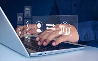 Hands typing on a laptop with digital icons floating above, depicting online banking transactions, payment successful, and invoice management.