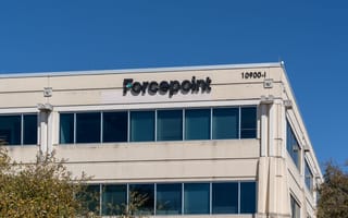 The image shows a beige office building with "Forcepoint" in large letters on the facade.