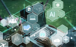 A person types on a laptop surrounded by translucent hexagons displaying symbols like AI, brain, and cloud, conveying innovation and technology themes.