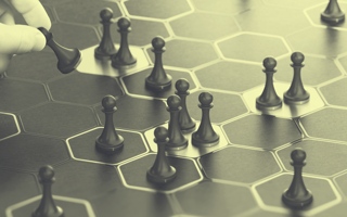 Board game with a hand moving pawns.