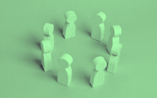 Wooden pieces in the shape of people in a circle.