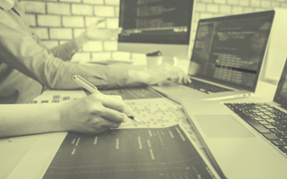 Two people working together on code.