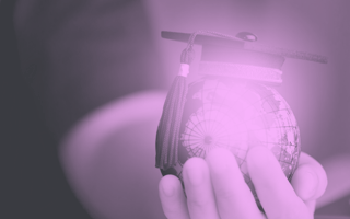 A hand holds a glowing globe wearing a graduation cap