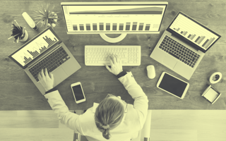 A business analyst works across multiple devices