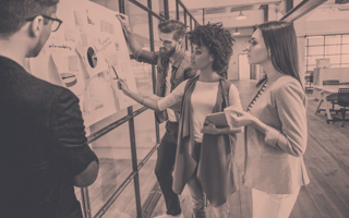 A group of people collaborate on a plan