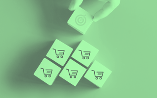Wooden blocks with carts on them. A person is adding a block with a bullseye on it.
