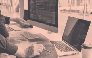 Two people looking over code.