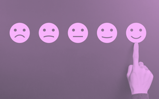 Do Surveys Really Help Prevent Churn? Smiley faces ranging from sad to happy in a row to indicate feedback. A hand picking happy.