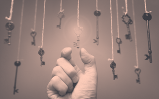 Hand reaching for a hanging key.