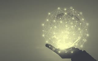 A hand holding art of connected dots.