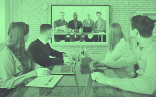 employees viewing coworkers through projector screen