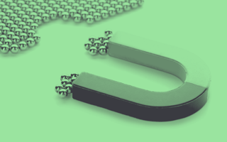 A magnet attracting metallic balls.