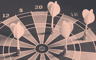 Four darts that have missed their targets on the dartboard.