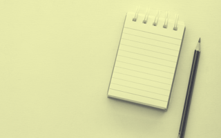 A blank notepad with a pencil next to it.