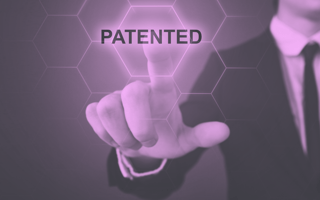 Businessperson pressing the word "patented."