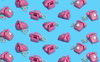 pink rotary dial phones in front of a blue background