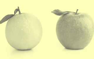 An apple to an orange next to each other.