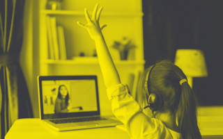 Child raising their hand while watching an online lesson.