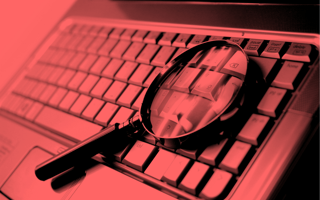 keyword research. Magnifying glass on keyboard.
