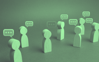Wood figures with speech bubbles over their heads.