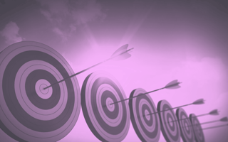 A row of targets with arrows in the center.