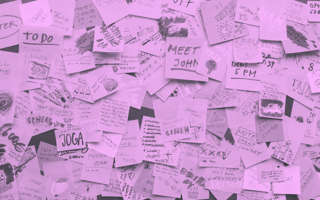 A wall covered with post-its with a variety of tasks on them.