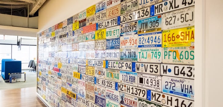 A wall of license plates in CarGurus' Boston office